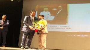 Girish Pant receiving an award for his generous work in Dubai.