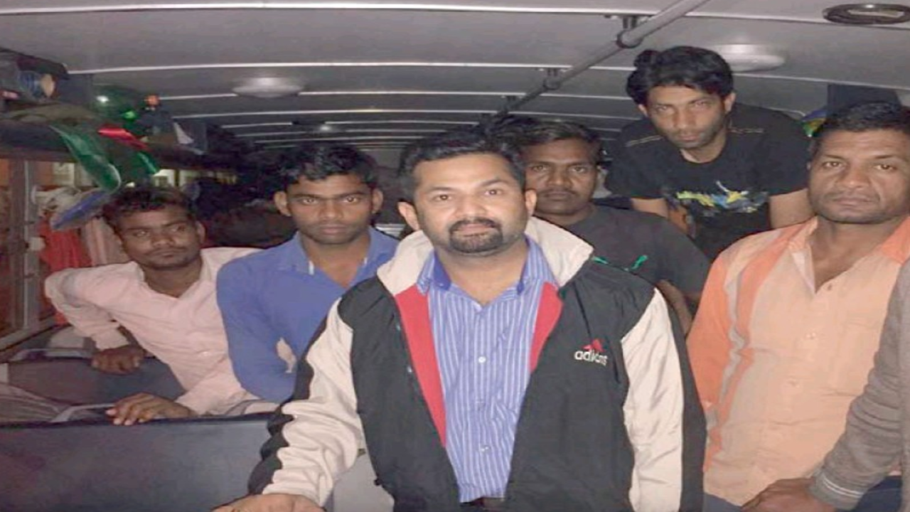 You are currently viewing Girish Pant with a group of work­ers in dis­tress
